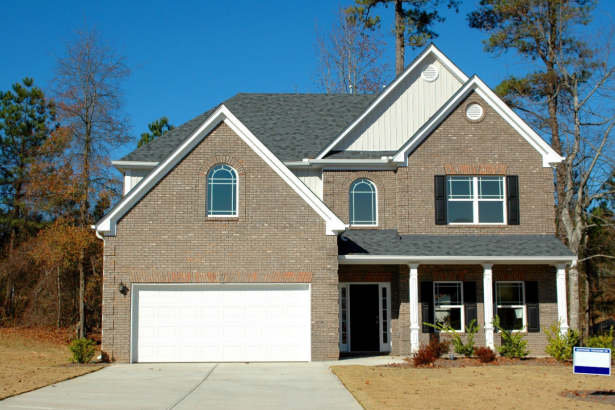 red-bricked house with wooden garage door