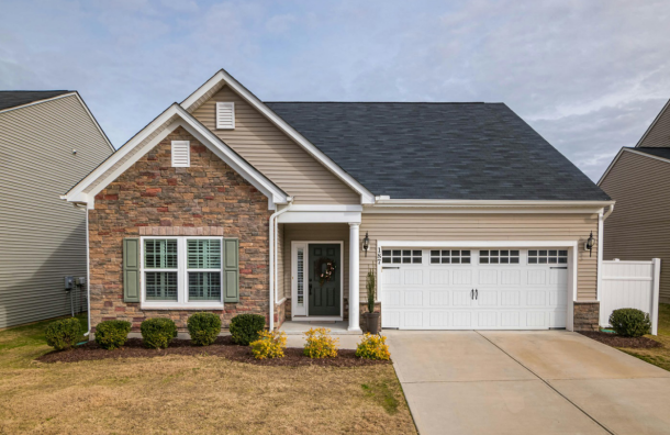 red-bricked house with wooden garage door